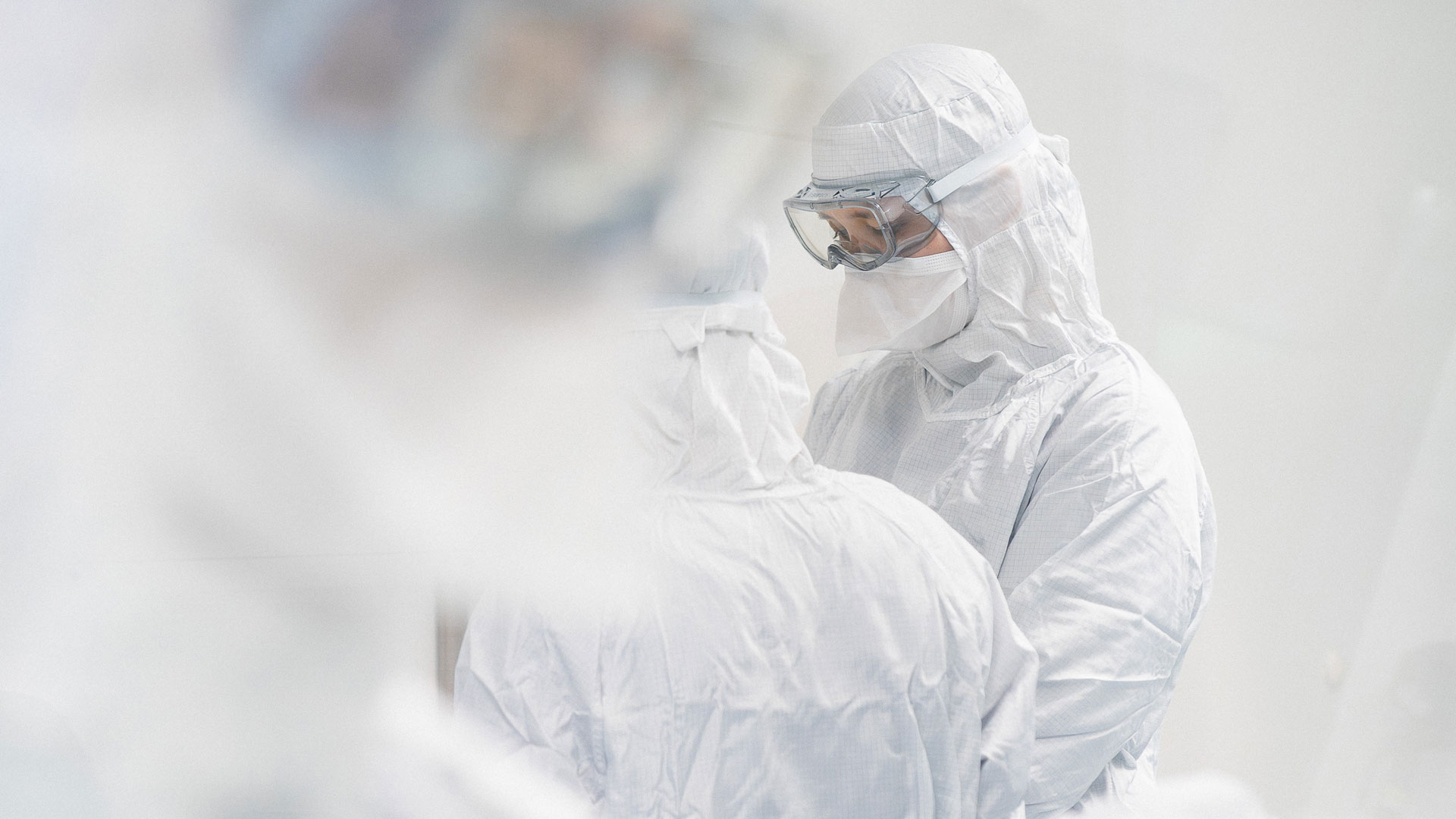 Employees preparing sterile infusion in a cleanroom